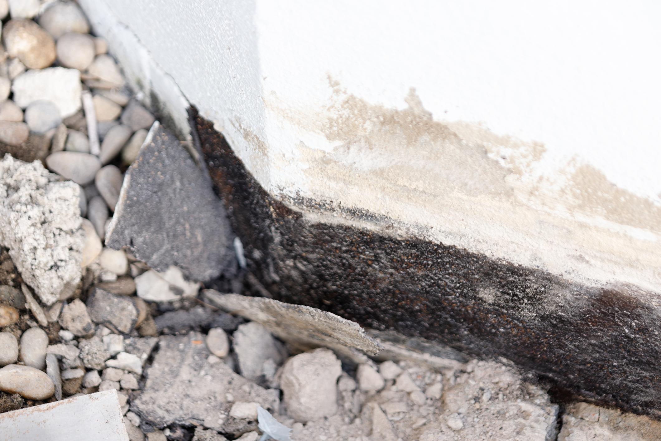 water damage on concrete foundation wall with mold